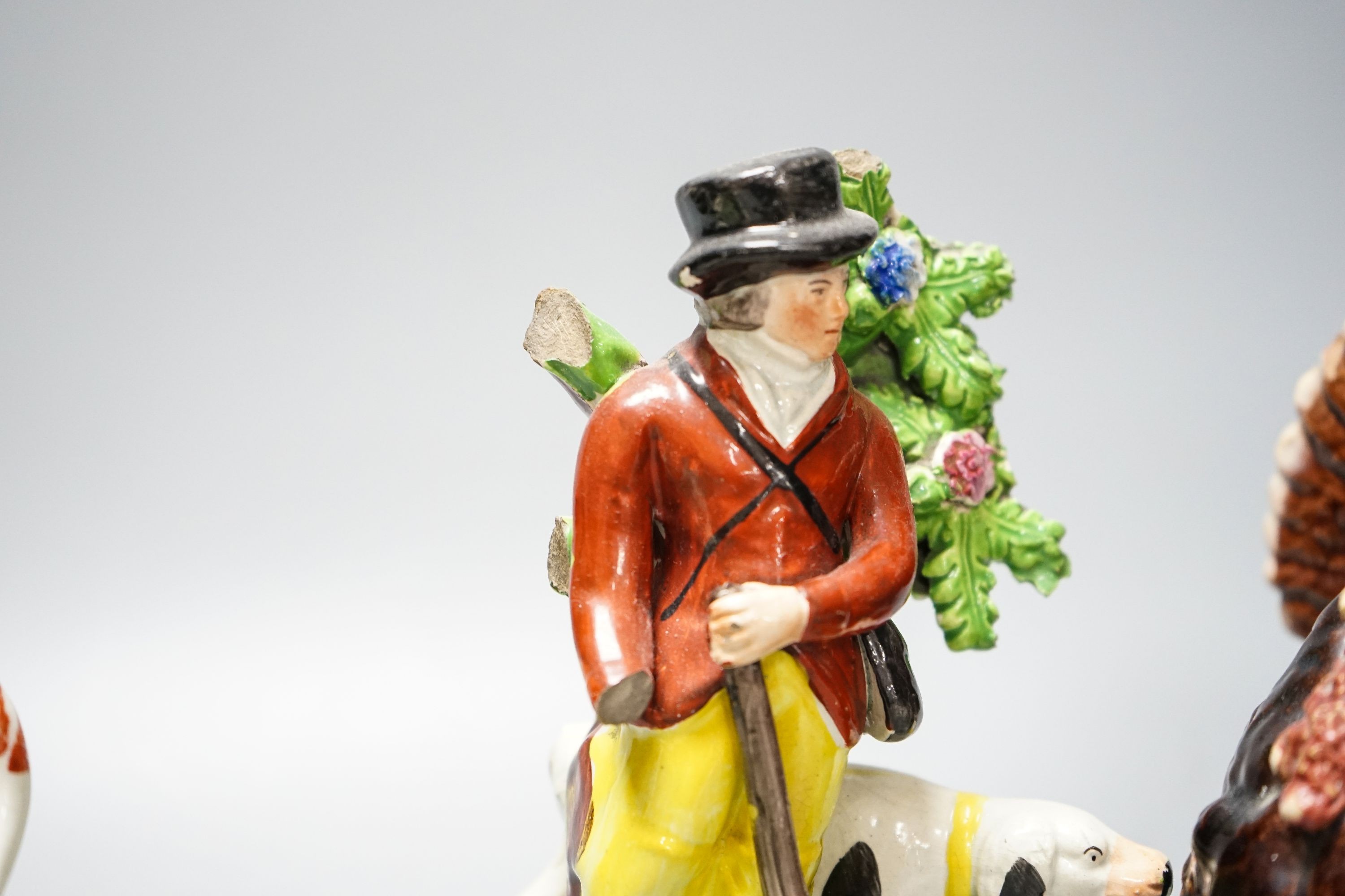 A 19th century 'Milkmaid and cow' creamer with sponged decoration, three other Staffordshire items and a Continental majolica figure of a turkey (5)